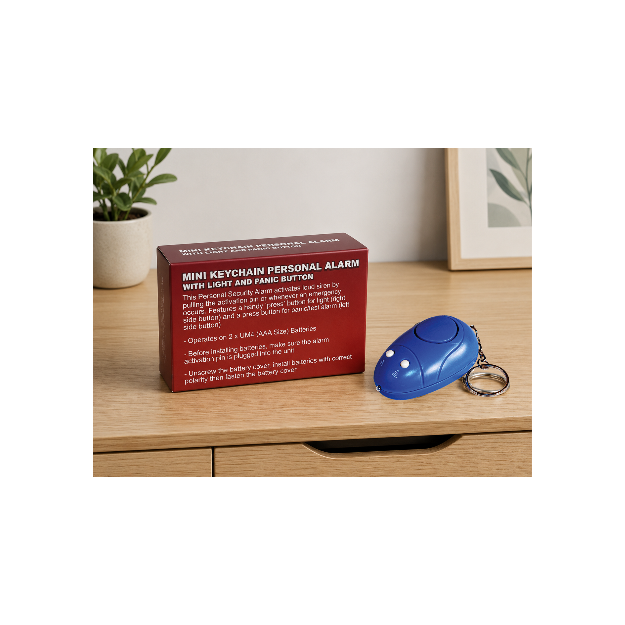 Blue keychain personal safety alarm with light displayed beside its product packaging