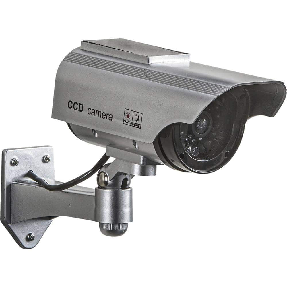 Silver solar-powered dummy security camera with rain shield and mounting bracket on a white background.