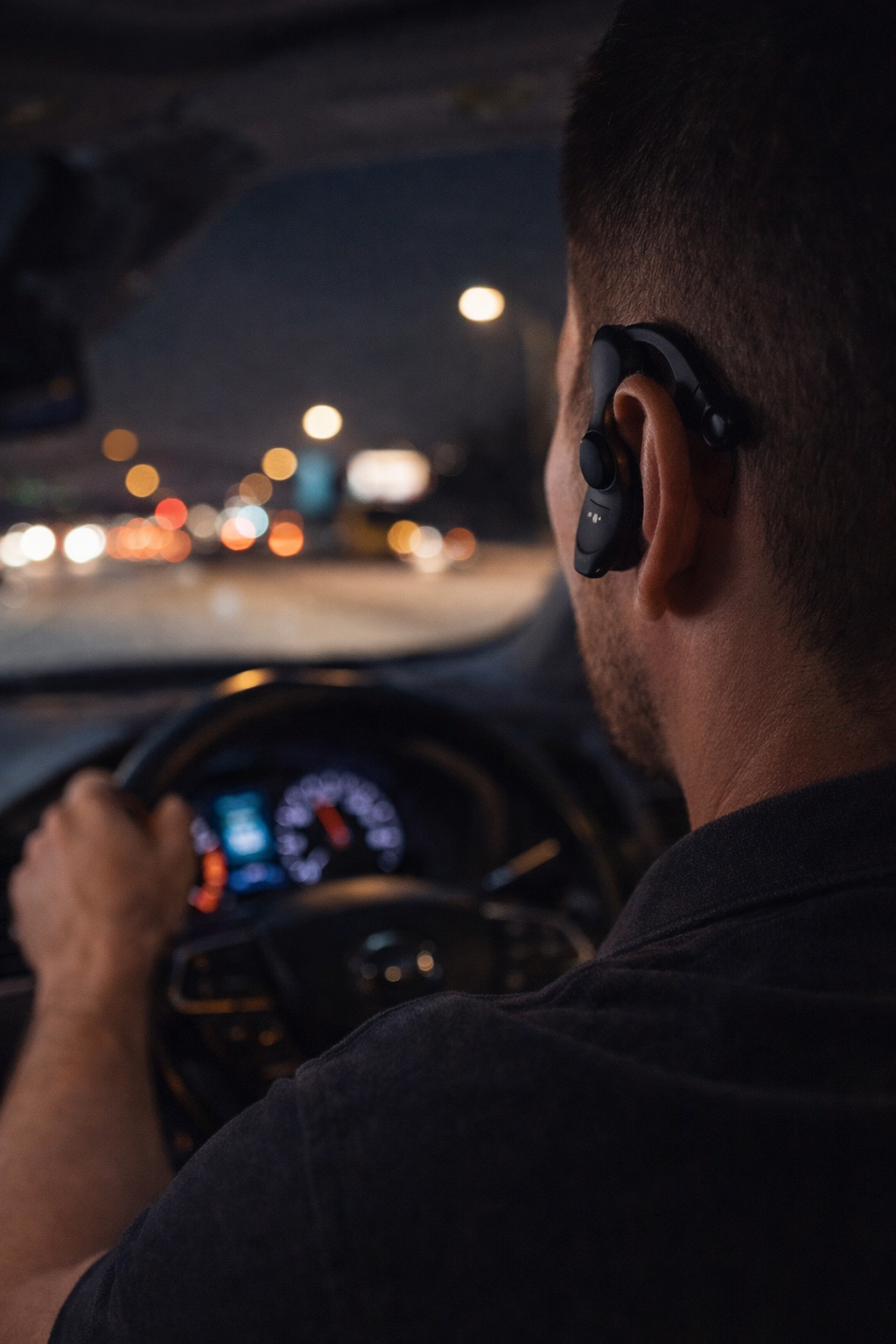 Driver practicing nighttime safety awareness while traveling on a city road